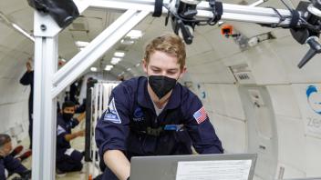Preston working on laptop in-flight