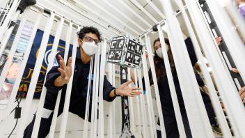 Chris floating with CubeSat 