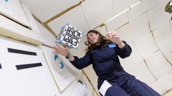 Kylie with floating CubeSat - Flight Campaign 3