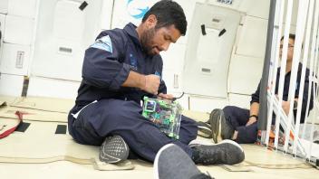 Abhay Negi fixing CubeSat in Zero-G
