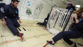 Abhay Negi and Kylie Cooper with CubeSat in Zero-G