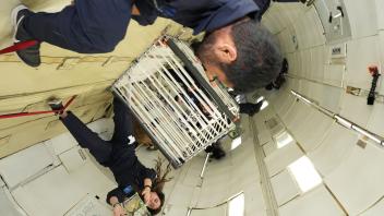 Kylie Cooper and Abhay Negi with CubeSat in Zero-G