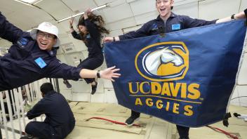 Preston Vanderpan with UC Davis flag in Zero-G