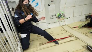 Kylie Cooper with CubeSat in Zero-G