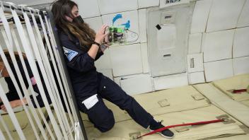 Kylie Cooper with CubeSat in Zero-G