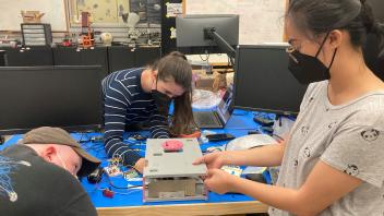 Cordell, Kylie, and Miranda during CubeSat fit-check at JSC