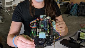 Kylie holding CubeSat 